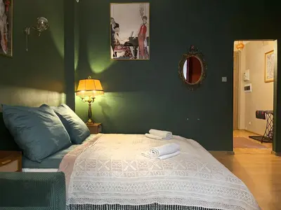 a bed with two towels on it in a bedroom at Cozy Apartment Inspiro, Cracow Old Town in Kraków