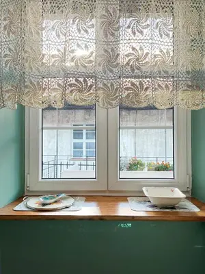 a table with two windows in a room at Cozy Apartment Inspiro, Cracow Old Town in Kraków