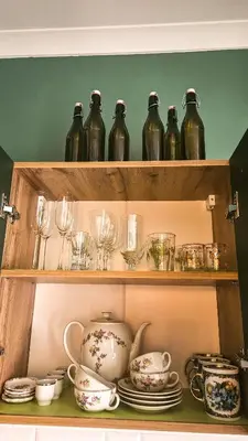 a shelf filled with dishes and tea pots and cups at Cozy Apartment Inspiro, Cracow Old Town in Kraków