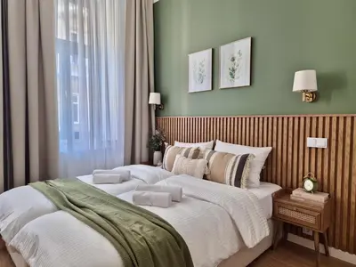 a bedroom with a bed and a table at Wawel Square Residence in Kraków