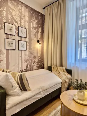 a bedroom with two beds and a window at Wawel Square Residence in Kraków