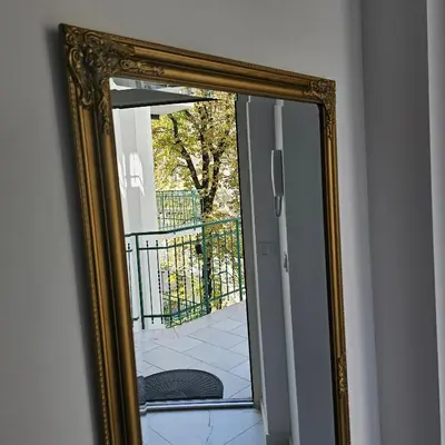 a mirror hanging on a wall next to a door at Juwel Apartments z widokiem na Wawel 32 in Kraków