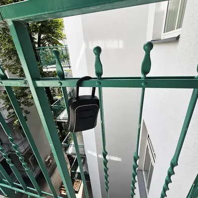 a purse hanging on the railing of a balcony at Juwel Apartments z widokiem na Wawel 32 in Kraków