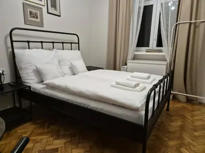 a bed with two towels on it in a bedroom at Plac Matejki Apartments by Noah in Kraków