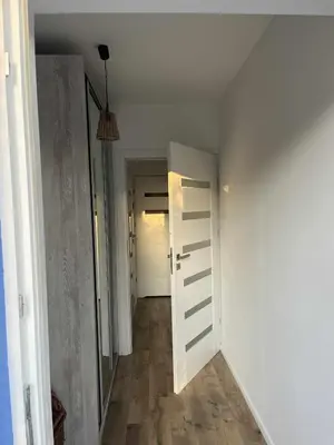 a hallway with a white door and a hallway with a hallway at Blue cottage near Krakow in Rudawa