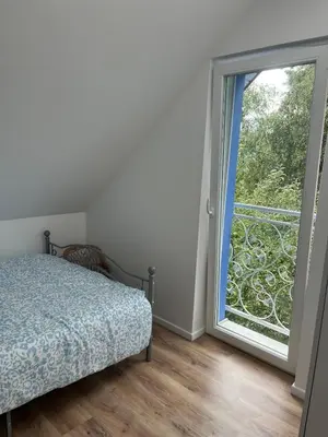 a bedroom with a bed and a large window at Blue cottage near Krakow in Rudawa