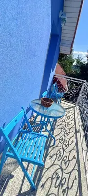 a blue table and chair sitting on a patio at Blue cottage near Krakow in Rudawa