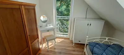 a bedroom with a bed and a dresser and a window at Blue cottage near Krakow in Rudawa