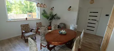 a dining room with a wooden table and chairs at Blue cottage near Krakow in Rudawa