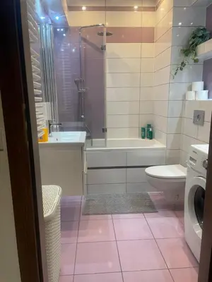 a bathroom with a tub and a toilet and a sink at Apartament z ogrodem w Krakowie in Kraków