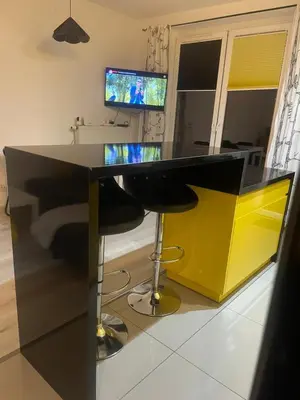 a yellow and black desk in a room with a computer at Apartament z ogrodem w Krakowie in Kraków
