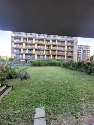 a large building with a lawn in front of it at Apartament z ogrodem w Krakowie in Kraków