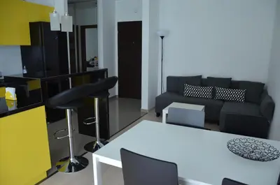a living room with a white table and a couch at Apartament z ogrodem w Krakowie in Kraków