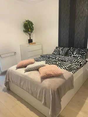 a bed with pillows on it in a bedroom at Apartament z ogrodem w Krakowie in Kraków