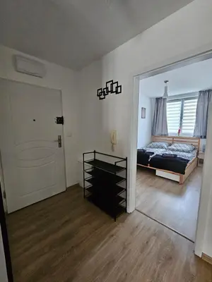a bedroom with a bed and a mirror at Grey Apartment in Kraków