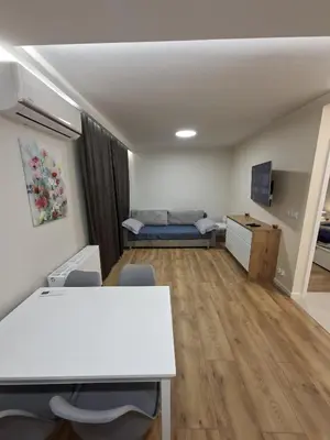 a room with a table and chairs and a couch at Apartament Rydlówka 39 in Kraków