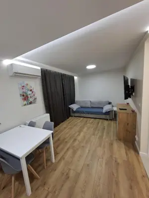 a living room with a table and a couch at Apartament Rydlówka 39 in Kraków