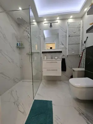 a bathroom with a shower and a toilet and a sink at Apartament Rydlówka 39 in Kraków