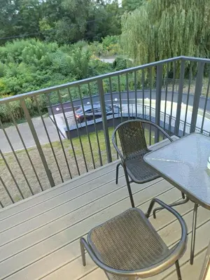 a table and two chairs on a deck with a table and a table at Apartament Rydlówka 39 in Kraków