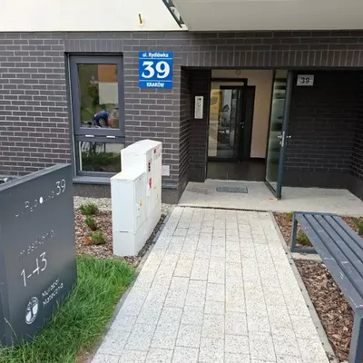 a building with a sign in front of a building at Apartament Rydlówka 39 in Kraków