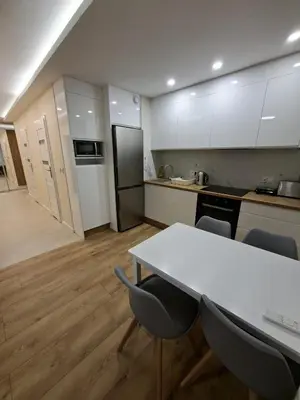 a kitchen with a table and chairs in a room at Apartament Rydlówka 39 in Kraków