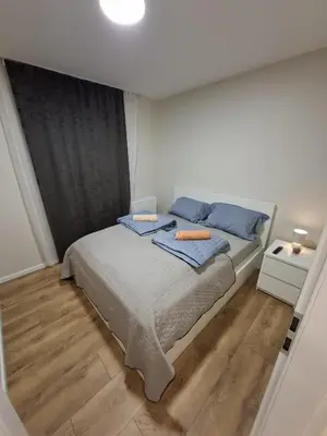 a bedroom with a bed with two towels on it at Apartament Rydlówka 39 in Kraków