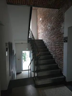 a staircase in a building with a brick wall at Różana Near Wawel Castle in Kraków