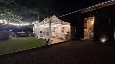 a white tent in a yard at night at Dom w zaciszu stodoły