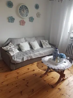 a living room with a couch and a coffee table at Dom w zaciszu stodoły