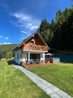 a house with a deck on top of a yard at Arkadia pod Diablakiem in Zawoja
