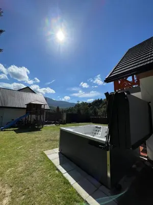 a hot tub on the side of a house at Arkadia pod Diablakiem in Zawoja