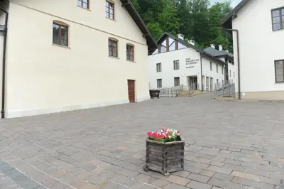 a basket of flowers sitting in a courtyard next to a building at Dom Pielgrzyma KARMEL in Krzeszowice