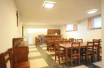 a dining room with wooden tables and chairs at Dom Pielgrzyma KARMEL in Krzeszowice