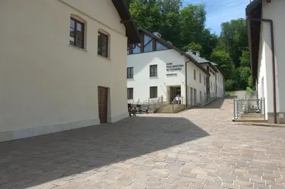 a large white building with a patio in front of it at Dom Pielgrzyma KARMEL in Krzeszowice