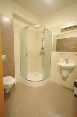 a bathroom with a shower and a toilet and a sink at Dom Pielgrzyma KARMEL in Krzeszowice