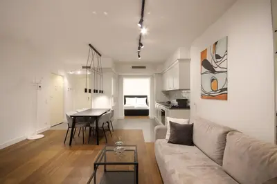 a living room with a couch and a table at Wawel Apartments by Noah in Kraków