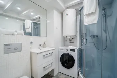 a bathroom with a washing machine and a shower at Grzegórzki Studio - Entresol, Top Location - by Rentujemy in Kraków