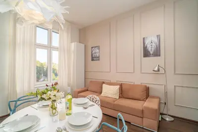 a living room with a table and a couch at Grzegórzki Studio - Entresol, Top Location - by Rentujemy in Kraków
