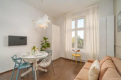 a living room with a couch and a table at Grzegórzki Studio - Entresol, Top Location - by Rentujemy in Kraków