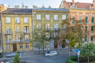 an apartment building with cars parked in front of it at Grzegórzki Studio - Entresol, Top Location - by Rentujemy in Kraków