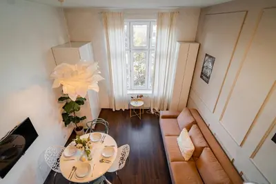 a small living room with a table and a couch at Grzegórzki Studio - Entresol, Top Location - by Rentujemy in Kraków