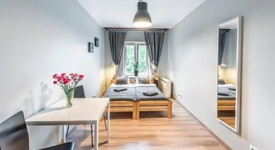 a small room with a bed and a table at Fenna Apartments 7 minut od Rynku in Kraków