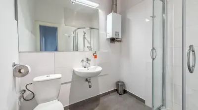 a bathroom with a toilet and a sink and a shower at Fenna Apartments 7 minut od Rynku in Kraków