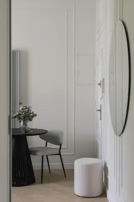 a room with a table and a chair and a mirror at Wawel View I Koletek 17 in Kraków