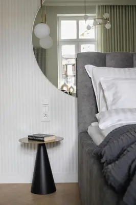 a bedroom with a bed with a mirror and a table at Wawel View I Koletek 17 in Kraków