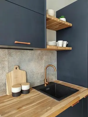 a kitchen with a sink and a counter top at Meiselsa Apartments by Noah in Kraków