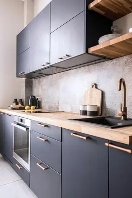 a kitchen with blue cabinets and wooden counter tops at Meiselsa Apartments by Noah in Kraków