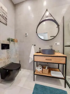 a bathroom with a sink and a mirror at Meiselsa Apartments by Noah in Kraków