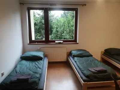 a room with two beds and a window at Kwatery pracownicze Kęty Zielona in Kęty