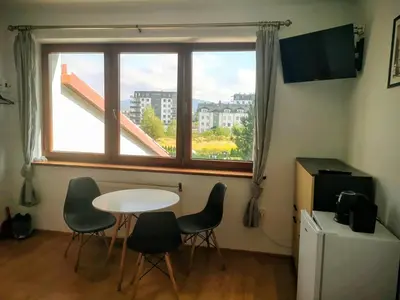 a room with a table and chairs and a window at Kwatery pracownicze Kęty Zielona in Kęty